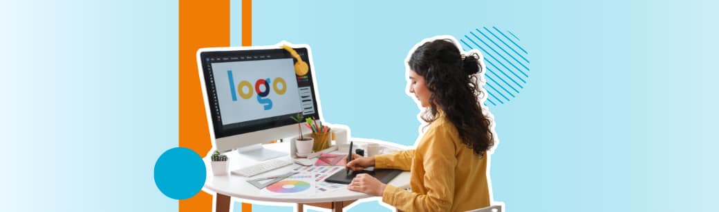 A graphic designer in the Philippines working at a desk with a computer, creating a colorful logo design.