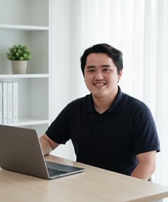 LevelUp team member working on a laptop in a bright office setting.
