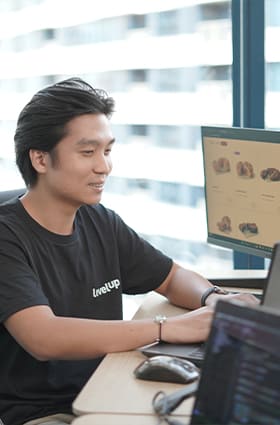 Administrative_02 A man wearing a black shirt is seated at a desk, typing on a keyboard.