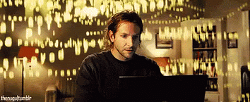 Person working on a laptop surrounded by visual elements representing AI-generated information