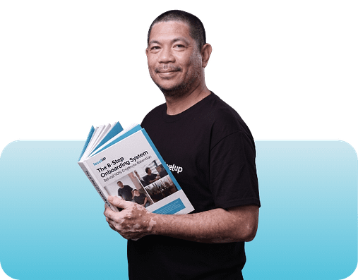 LevelUp team member holding The 8-Step Onboarding System guide related to why the first 30 days matter for offshore hires.