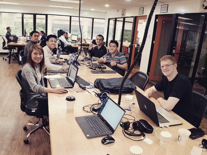 LevelUp team members working at shared desks in an office environment