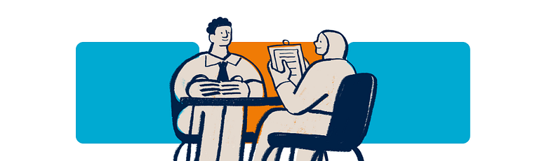 Two people sitting across a table discussing documents