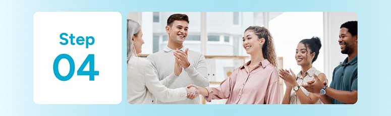 Colleagues shaking hands and smiling, representing structured onboarding and communication routines for offshore hires.