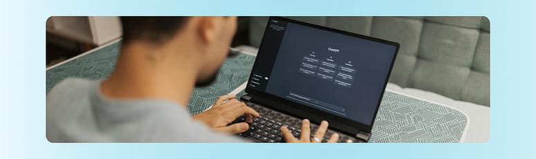 Person typing on a laptop screen showing ChatGPT, representing the use of AI tools in team workflows.