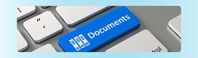 Keyboard with a blue “Documents” key, symbolizing digital documentation and notes for remote teams.
