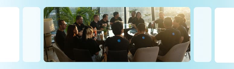 LevelUp team gathered around a round table in discussion, highlighting teamwork, collaboration, and shared motivation within the company.