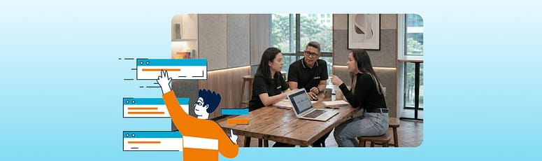 Collaborative Distributed Team at Work Three professionals from LevelUp sit around a table with a laptop, engaged in an active discussion