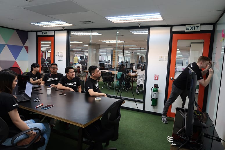 LevelUp team members seated in a meeting room during a feedback discussion