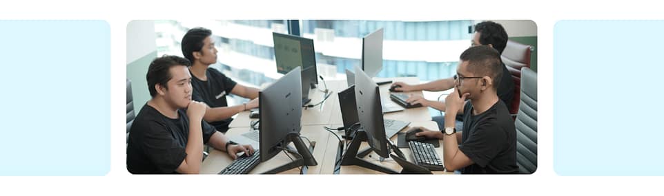 A group of offshore bookkeepers in the Philippines working together at computers in a modern office, supporting small businesses and agencies with reliable bookkeeping.