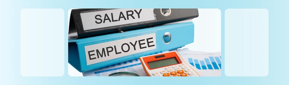Salary and employee binders with calculator on a desk