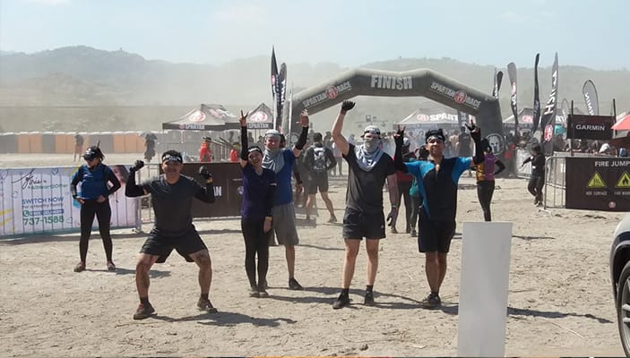 LevelUp team celebrating at a Spartan race finish line