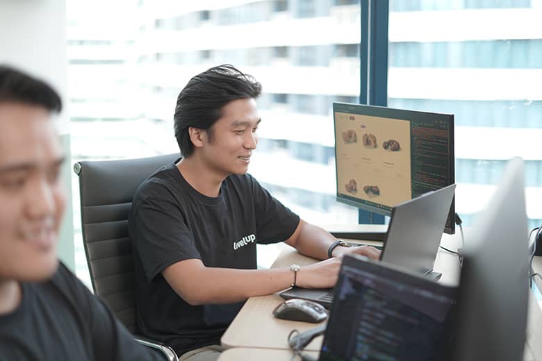 A team of offshore software developers working together on a project in a well-lit, collaborative workspace.