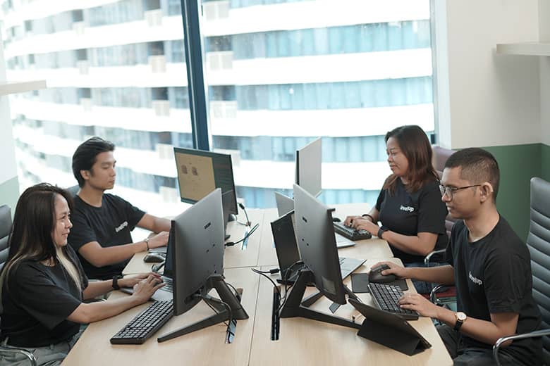 Professionals working at computers in a modern office.