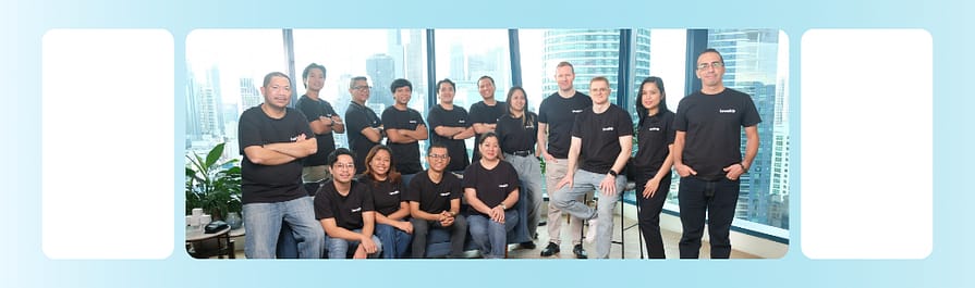LevelUp offshore software development team The LevelUp Philippines software development team poses together in an office with city views, representing the strength and stability of long-term offshore partnerships.