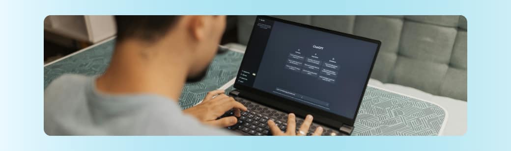 Person typing on a laptop screen showing ChatGPT, representing the use of AI tools in team workflows.