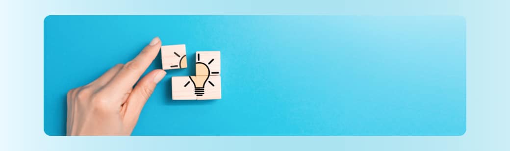 A hand placing puzzle pieces together with a lightbulb icon, symbolizing turning creative briefs into ideas.