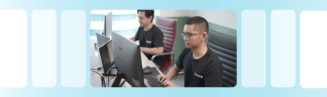LevelUp team members working at their desks, representing the company’s hands-on approach to candidate engagement and communication.
